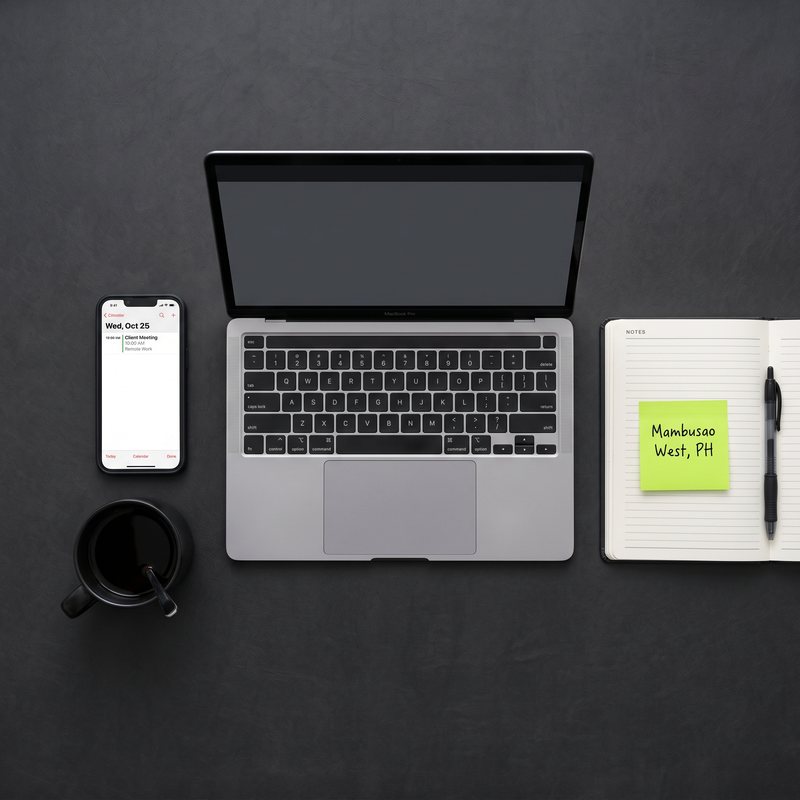 Organized remote workspace with laptop, notebook, and calendar